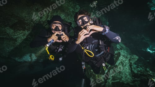 Preview: TWO DIVERS DOING HEARTS WITH THE HANDS IN A CENOTE