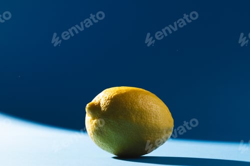 Preview: Close up of lemon and copy space on blue background