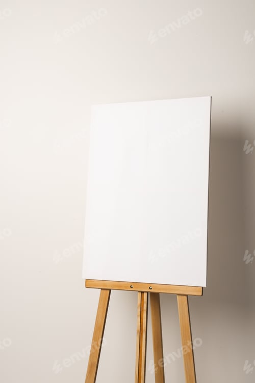 Preview: White canvas on wooden easel and copy space on white background