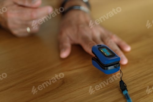 Preview: Close-up image of a hand of a male measuring oxygen saturation.