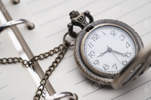 Preview: An Exquisite Vintage Pocket Watch Resting Gracefully on an Open Planner or Diary Page