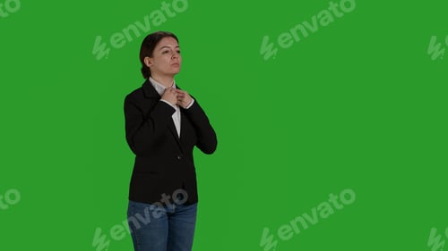 Preview: Side view of businesswoman standing on green screen backdrop