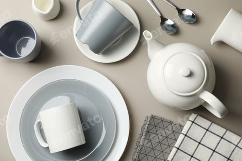 Preview: Table setting with teapot on grey background, top view