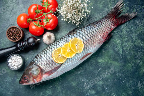 Preview: top view fresh raw fish with tomatoes and lemon on dark blue background shark seafood meal ocean