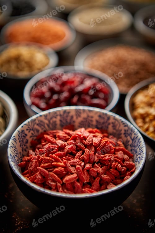 Preview: Raw goji berries in ceramic bowl. Selective focus