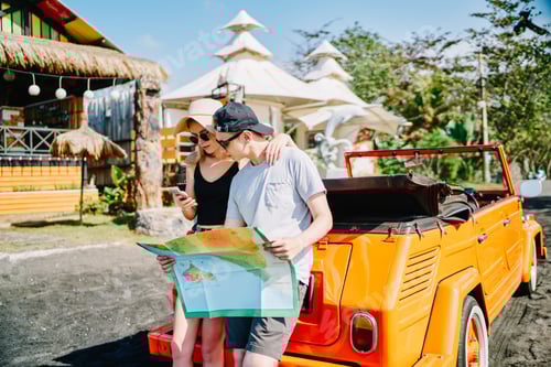 Preview: Young Couple Navigating Scenic Route with Map