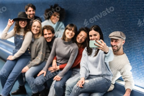 Preview: Happy young friends having fun doing selfie in metro subway station