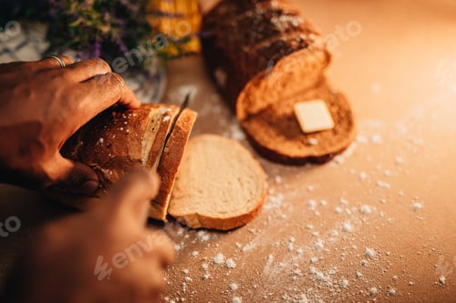 Preview: Man cutting a piece of freshly baked bread