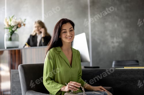 Preview: Woman at reception desk of a modern clinic