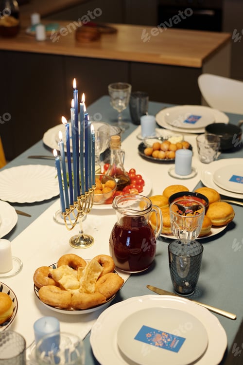 Preview: Served table with nine branch candlestick menorah surrounded by homemade treats
