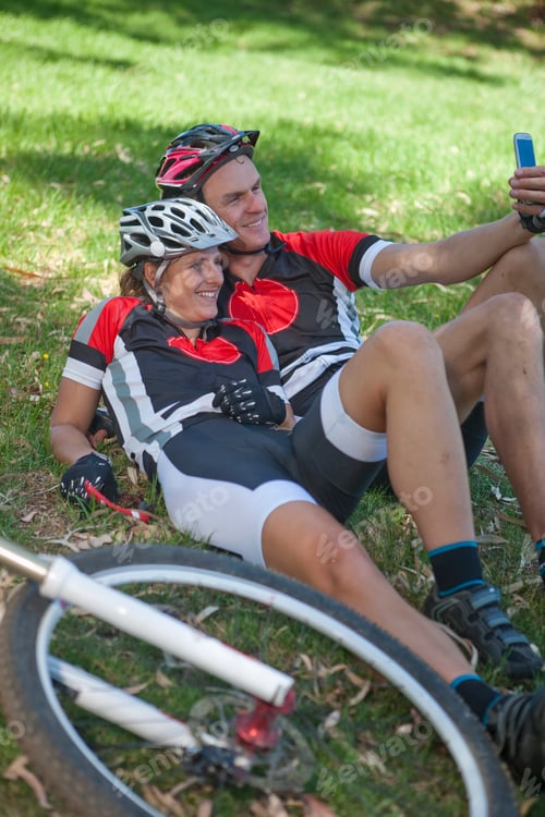 Preview: Smiling Cyclists Relaxing and Taking a Selfie Outdoors