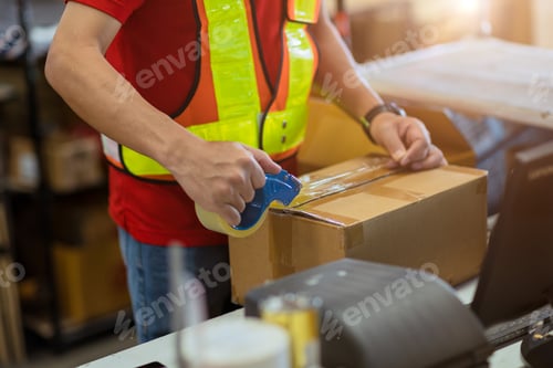 Preview: staff worker tape packing seal products box prepare for shipping delivery to online order customer.