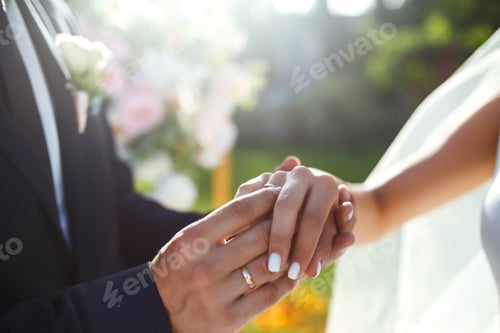 Preview: Wedding engagement rings. Newlywed couple's hands with engagement rings. Young couple at ceremony.