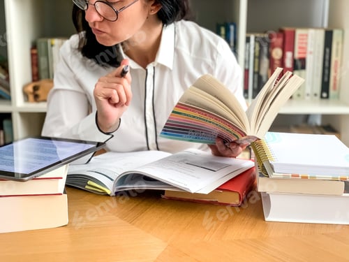 Preview: Candid millennial young woman is studying or working from home. Freelancer. Studying, making report