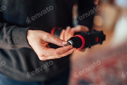 Preview: Closeup of Hands Using a Cordless Power Drill for Assembly Work