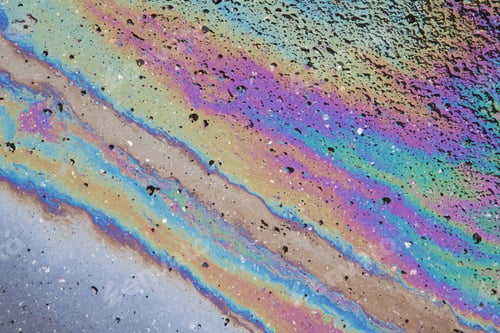 Preview: Petrol stain on asphalt road, big polluted puddle water.