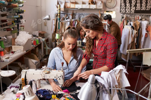 Preview: Colleague advises trainee machinist at clothes design studio