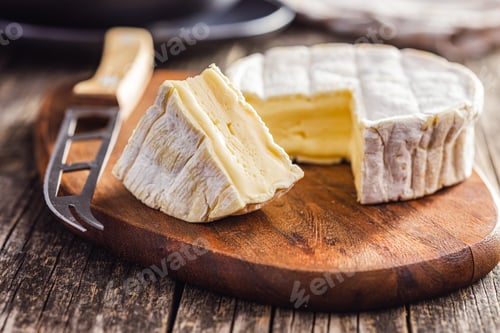 Preview: Brie type cheese with white mold. French camembert cheese on cutting board.