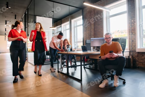 Preview: A diverse group of business professionals collaborates in a modern startup coworking center
