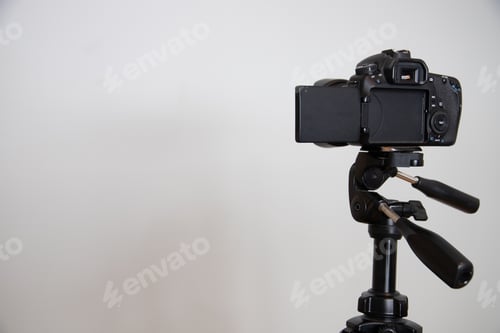 Preview: Black camera against a white wall with copy space