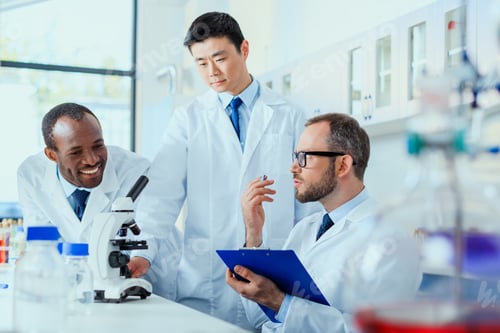 Preview: young doctors in uniform working at testing laboratory, laboratory technicians