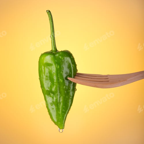 Preview: Green padron pepper on orange background.