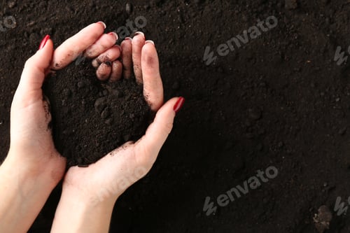 Preview: Woman with pile of fresh soil, top view. Space for text