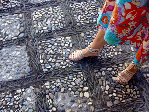 Preview: Woman's footwear on background of cobblestones