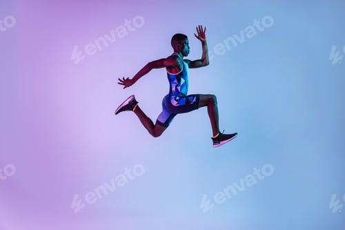 Preview: Running black sportsman in purple studio
