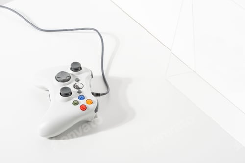 Preview: White gaming controller on white floor