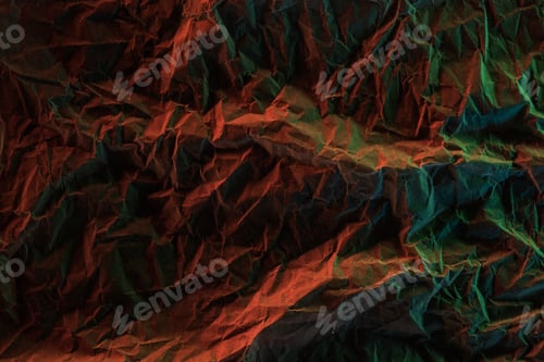 Preview: top view of crumpled paper with colorful lighting in darkness
