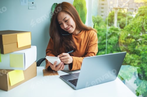 Preview: Entrepreneur confirming and noting orders from customer on the phone