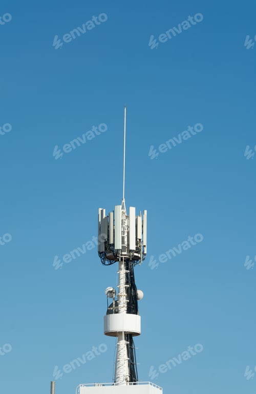 Preview: Vertical shot of a cell tower on background of the clear blue sky
