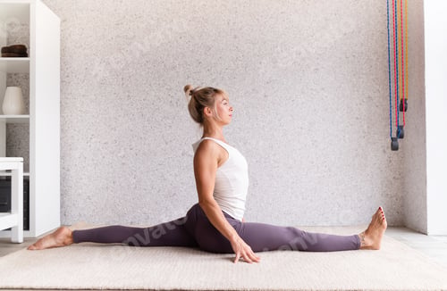 Preview: Young attractive woman practicing yoga, wearing sportswear on gray background