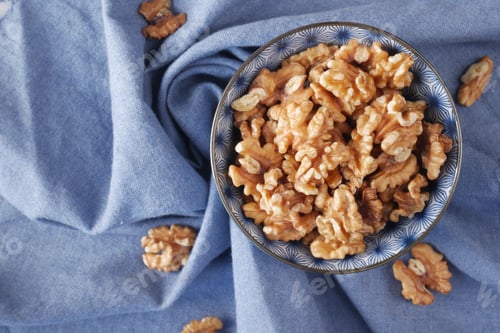 Preview: walnut on a plate on table , close up.