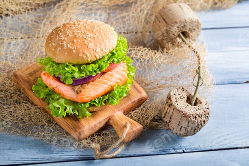 Preview: Homemade fishburger with salmon on old wooden table