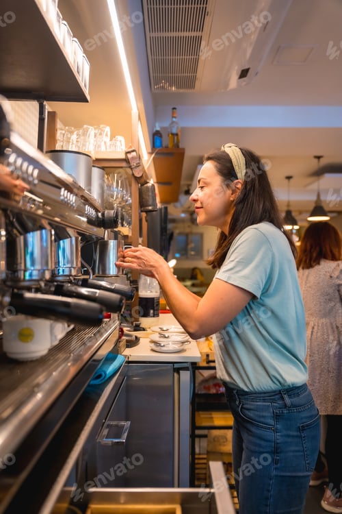 Preview: Owner of the female cafeteria preparing coffee in a coffee machine, the restrictions due to covid