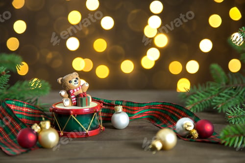 Preview: Christmas composition with cute teddy bear glass balls and fir on a wooden top with bokeh of lights