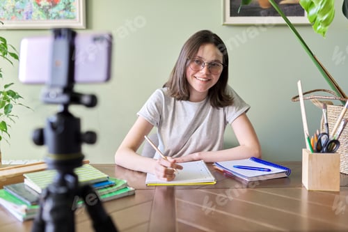 Preview: Girl student teenager studying online using smartphone, video conferencing