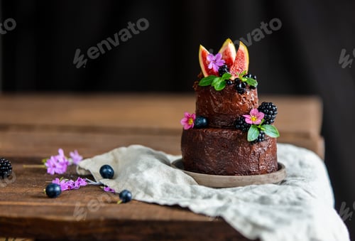 Preview: Chocolate cake with blackberry and common fig on wooden table