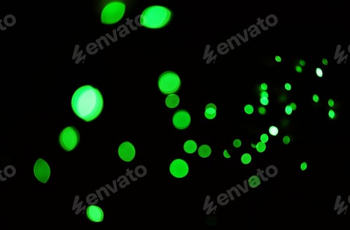 Preview: Green light, bokeh and glow on dark background isolated on a mockup space. Blur, black backdrop and