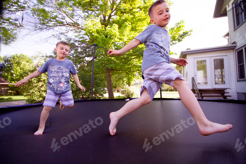 Preview: Kids jumping on a he trampoline having fun wide angle used