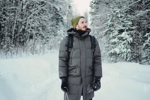 Preview: Young bearded man in the winter forest