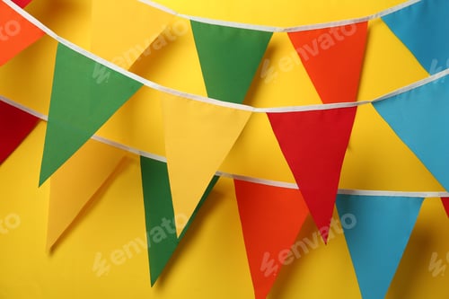 Preview: Buntings with colorful triangular flags on yellow background