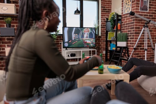 Preview: Men and women playing video games competition on tv