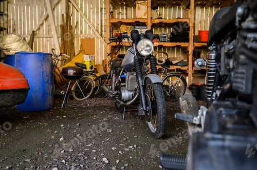 Preview: 10.10.2019 Helsinki, Finland - open garage space, with vintage motorcycle in storage on shelving.