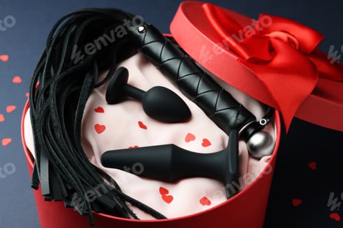 Preview: Gift box with different sex toy on dark blue background
