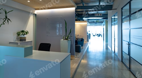 Preview: Empty chair at reception counter in modern illuminated office