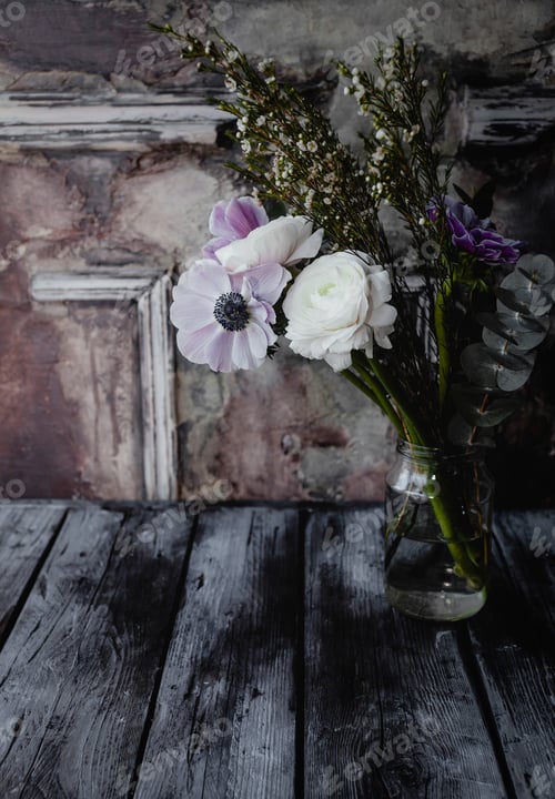 Preview: close up view of beautiful bouquet of flowers on glass jar on wooden surface