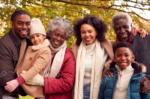 Preview: Portrait Of Smiling Multi-Generation Family Having Fun Walking Through Autumn Countryside Together